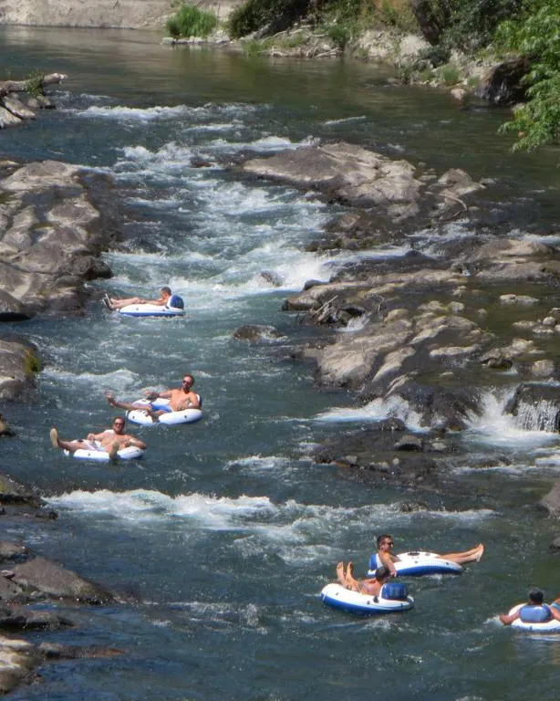 People floating down the Cowichan River on inner tubes on a summer day